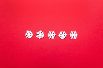 Festive christmas composition. Christmas frame made of snowflakes on pastel red background. Flat lay, top view, copy space