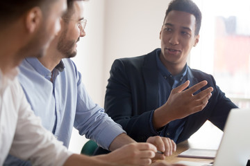 African american businessman offering idea at diverse team meeting