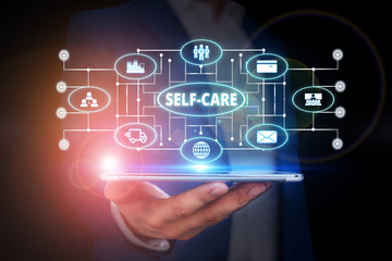 Word writing text Self Care. Business photo showcasing the practice of taking action to improve one s is own health Male human wear formal work suit presenting presentation using smart device