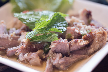 Hot and spicy grilled pork salad or Nam Tok Moo