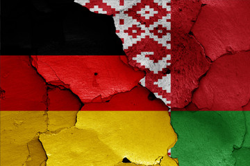 flags of Germany and Belarus painted on cracked wall