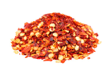 Ground chili and paprika, isolated on white background. Mix of hot and sweet red pepper with grains. Close-up.