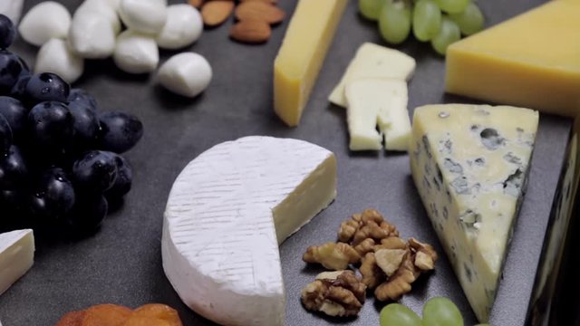 assorted cheeses, soft, hard, rennet and brine, and a glass of red wine