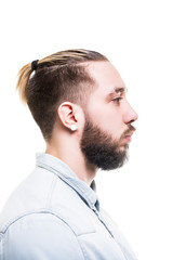 Closeup profile portrait of bearded caucasian man wearing shirt with serious look isolated at white background.