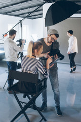 Professional photo studio. Fashion shooting. Creative team working on project.