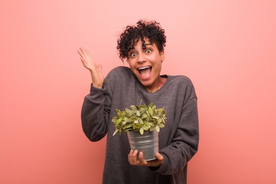 Young African American Woman With A Birthmark Holding A Plant Pot