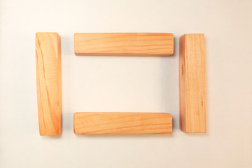 Wood bar pieces with shadows on white background. Vertical and horizontal wooden bars as concept of kids development toy, construction or decoration. Mockup frame section