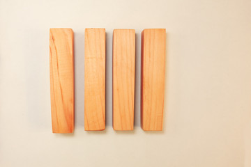 Wood bar pieces with shadows on white background. Vertical wooden bars as concept of kids development toy, construction or decoration. Mockup board or fence section