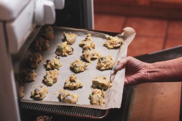 woman holding tray of cookies