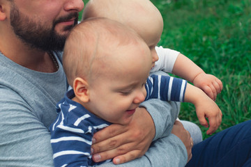 Dad teaches daughter to walk, park, nature. Walk on the grass. Father and daughter. First steps.