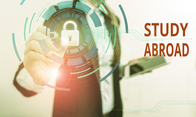 Writing note showing Study Abroad. Business concept for live in a foreign country and attend a foreign university Female human wear formal work suit presenting smart device