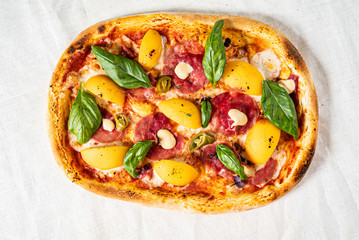 creative pizza with peach and sausage