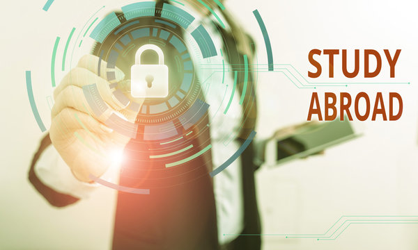 Writing note showing Study Abroad. Business concept for live in a foreign country and attend a foreign university Female human wear formal work suit presenting smart device