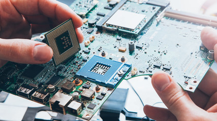 Tech support. Hardware repair. Engineer installing CPU on motherboard.
