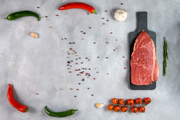 Raw fresh marbled meat and seasonings on grey background top view