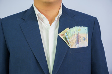 Money in Vietnam hold on hand business man wearing a blue suit (Socialist Republic Of Vietnam), Dong, VND, Pay, exchange money vietnamese on white background.