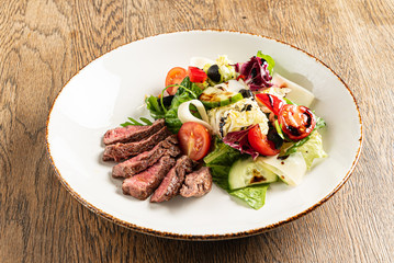 salad with beef on the wooden background