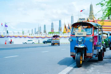 Wall murals Bangkok asia local travel in city activity with local taxi (tuk tuk) parking for wait tourism on street of bangkok Thailand with grand palace landmark background