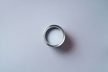 Open paint can with on pastel background. Top view, copy space. Appartment renovation, repair, building and home design concept.