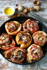 Baked apples in a pan with cinnamon, honey and spices. Healthy autumn dessert. The diet is friendly. Vegan Dessert. Selective focus. Macro.