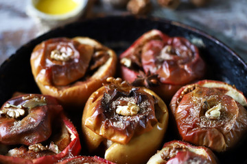 Baked apples in a pan with cinnamon, honey and spices. Healthy autumn dessert. The diet is friendly. Vegan Dessert. Selective focus. Macro.
