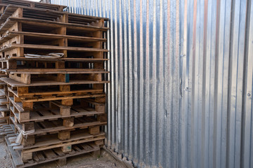 Old wooden pallet and rusty mechanisms in the workshop of an old abandoned factory.