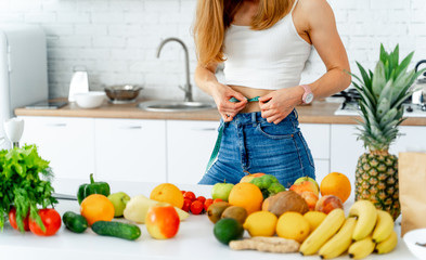 Dieting concept .Diet. Beautiful Young Woman near in the kitchen with healthy food. Fruits and Vegetables.