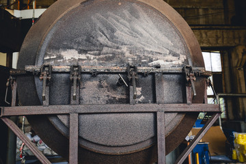 Rusty mechanisms and tools in the shop of an old abandoned factory.