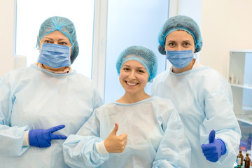 General photo of surgeons and a smiling patient after a successful operation