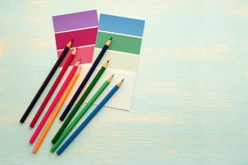 Colored wooden pencils on a white background. Creativity and drawing.