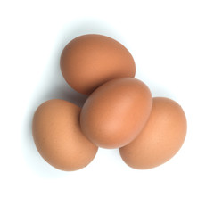 Top view four brown eggs separated from the white background.