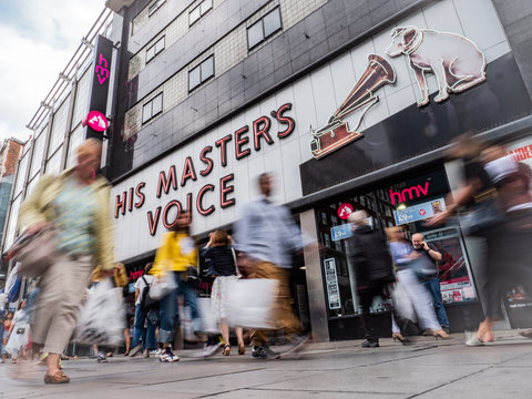 HMV, Oxford Street London. The shop front to the flagship store of the media retailer with long exposure anonymous blur of passing shoppers.