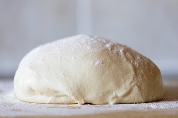 closeup of dough on wooden table
