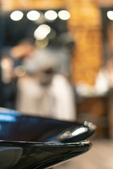 Haircut head in barbershop. Barber cuts the hair on the head of the client. The process of creating hairstyles for men. Barber shop. Selective focus.