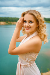 Fototapeta na wymiar portrait of a beautiful girl in a long dress on a cliff