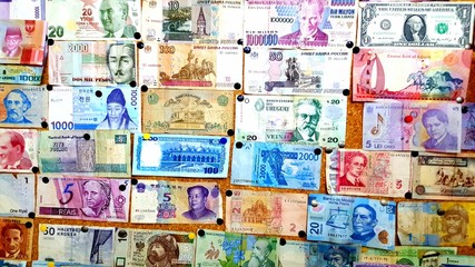 Currency of different countries background. Colorful banknotes of different countries as background close up.