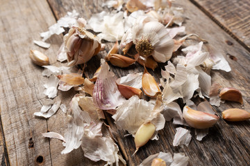 Raw garlic cloves on wooden background