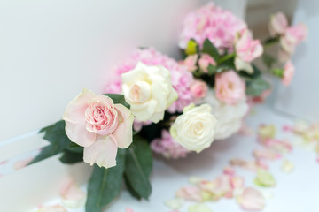 Wedding decorations. Holiday decoration vase with fresh flowers near the wedding arch. Pink roses and carnations