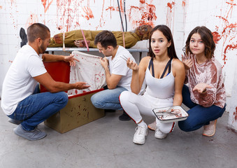 Young adults in escape room with traces of blood