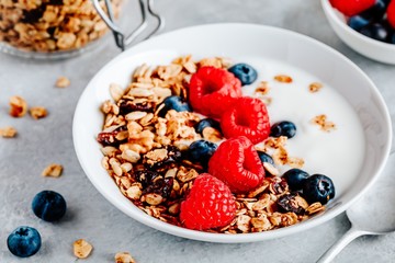 Healthy breakfast bowl homemade granola with fresh blueberry and raspberry