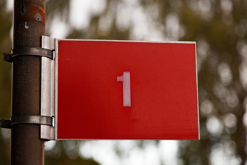 the number one on a red sign with white text, used by the fire brigade