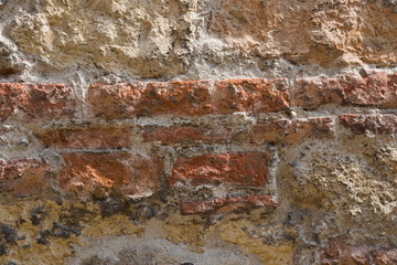 Vintage brick wall, bricks of different sizes are visible. Texture