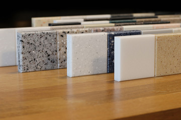Front view of color samples stone  on oak wood table, Acrylic Solid Surface