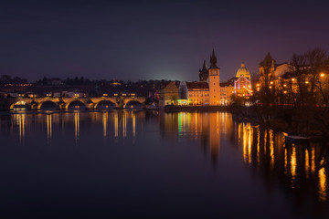 Scenic winter evening view of the Old Town ancient architecture and Vltava river pier in Prague, Czech Republic