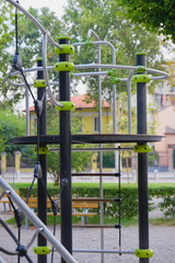 Fototapeta na wymiar Ladders and nets for climbing children on the playground, summer, no children yet. Europe, Italy