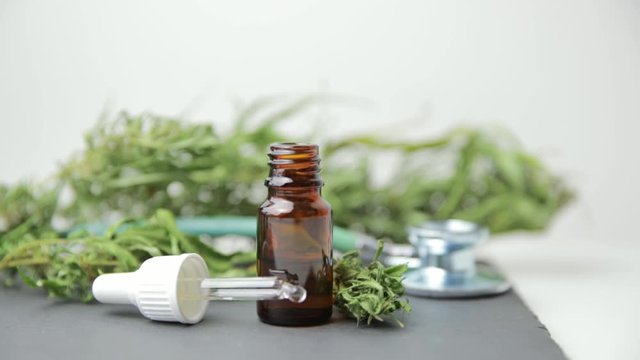 Medical marijuana cannabis cbd oil and stethoscope. Alternative medicine for pain relief