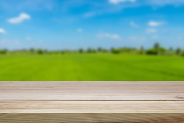 A wooden table on a blurred green background