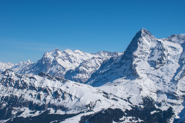 Naklejka na ściany i meble Swiss mountain peak after snowfall with panoramic view of Murren Jungfrau ski region.