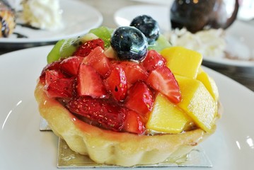 Cobbler tarts on wood tables, mango, strawberries, kiwi, blueberries