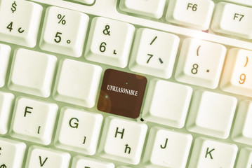 Text sign showing Unreasonable. Business photo text Beyond the limits of acceptability or fairness Inappropriate White pc keyboard with empty note paper above white background key copy space